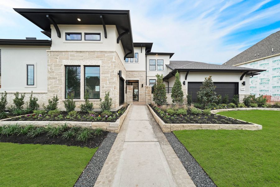 Front exterior of a new home in Elyson 45' & 70', Katy, TX, highlighting curb appeal (Image 2). Front exterior of a new home in Elyson 45' & 70', Katy, TX, highlighting curb appeal (Image 2).