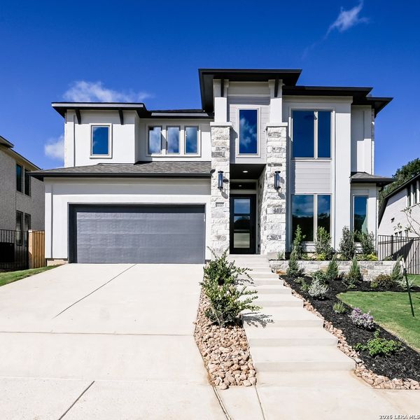 Front exterior of a new home in Hidden Canyon, San Antonio, TX, highlighting curb appeal (Image 21).