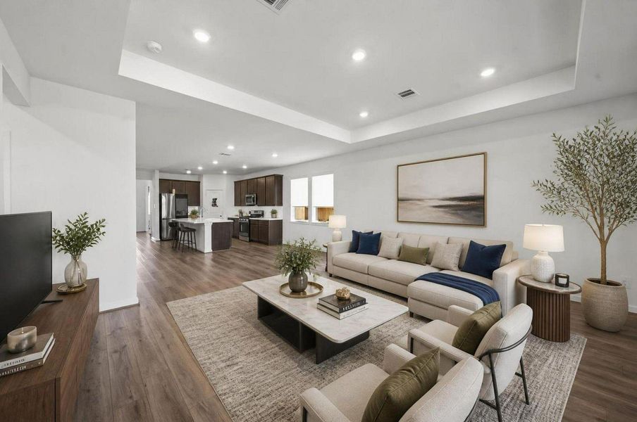 This view shows the full connection between the living room, kitchen, and dining area. The open-concept layout keeps the main floor bright, spacious, and easy to move through. Virtually staged. This view shows the full connection between the living room, kitchen, and dining area. The open-concept layout keeps the main floor bright, spacious, and easy to move through. Virtually staged.