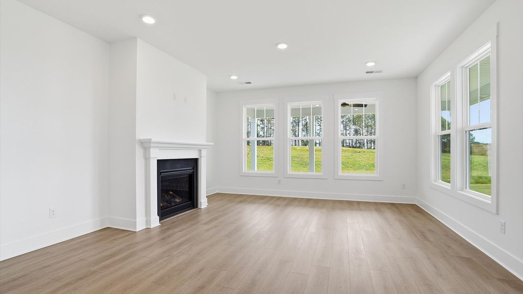 Thoughtful and stylish family room with fireplace ideal for gathering, relaxing, and living beautifully