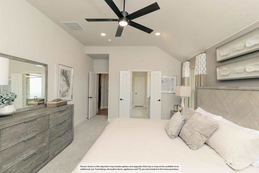 Master bedroom with vaulted ceiling, ceiling fan, upholstered headboard, and dresser with mirror