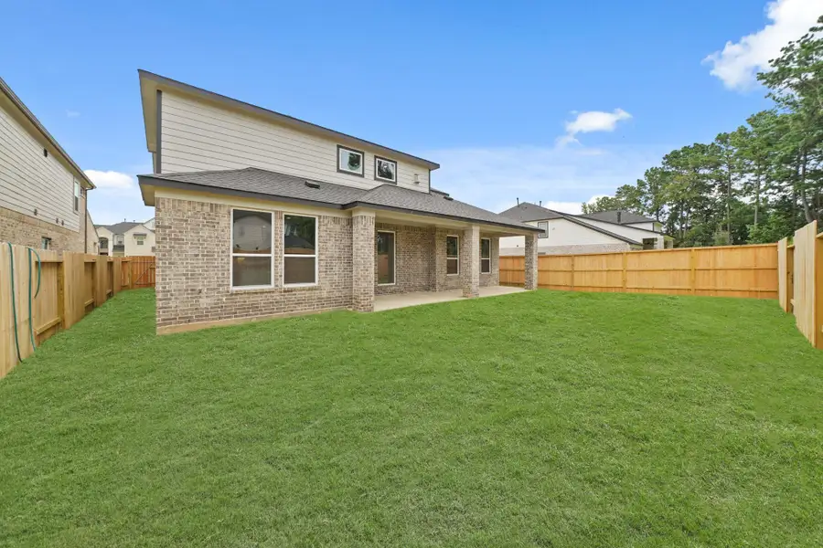 Front exterior of a new home in Barton Creek Ranch, Conroe, TX, highlighting curb appeal (Image 2). Front exterior of a new home in Barton Creek Ranch, Conroe, TX, highlighting curb appeal (Image 2).