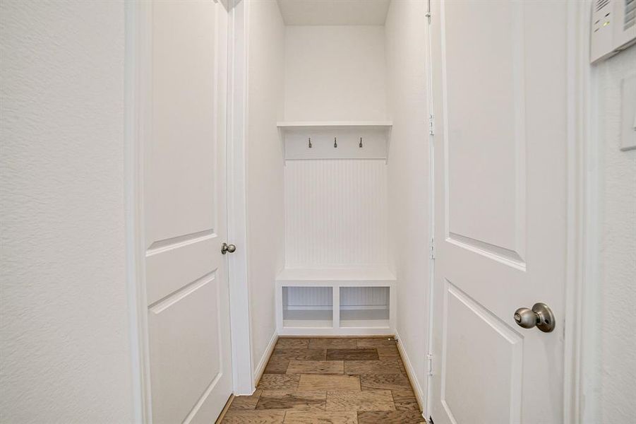 Garage entry to the right, custom mud bench addition and utility room to the left.