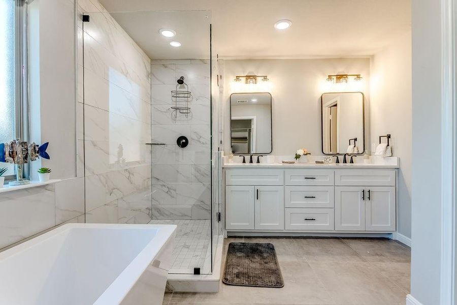 Bathroom featuring separate shower and tub, tile patterned flooring, and vanity