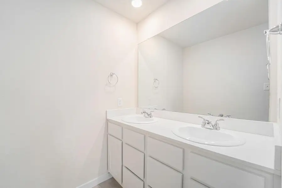 The upstairs shared bathroom features double sinks and a separate shower/tub combo. The upstairs shared bathroom features double sinks and a separate shower/tub combo.