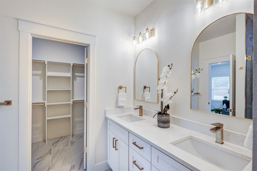 Bathroom featuring tile flooring and dual vanity