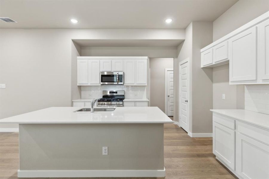 Kitchen in the Elm home plan by Trophy Signature Homes – REPRESENTATIVE PHOTO