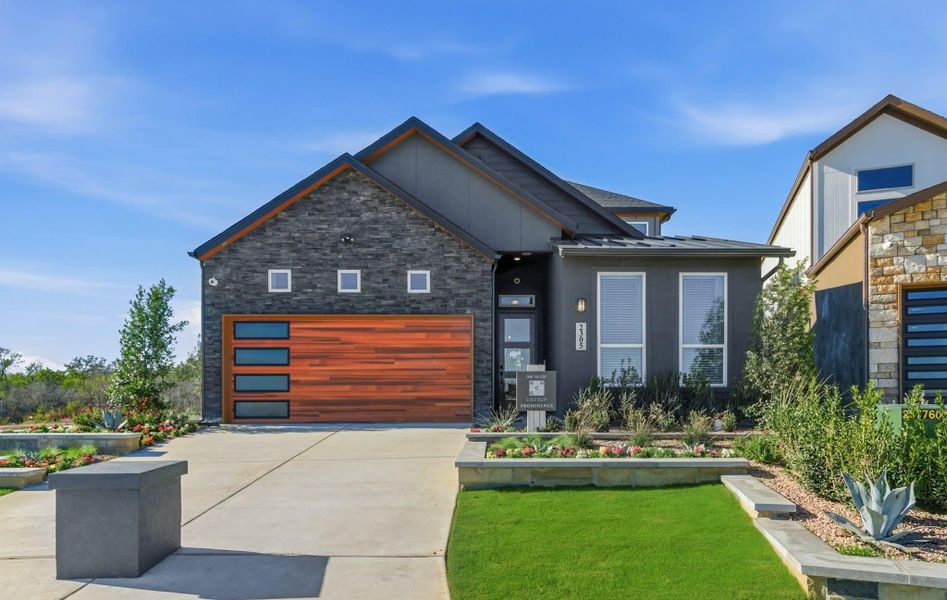 Front exterior of a new home in Prominence, San Antonio, TX, highlighting curb appeal (Image 23).