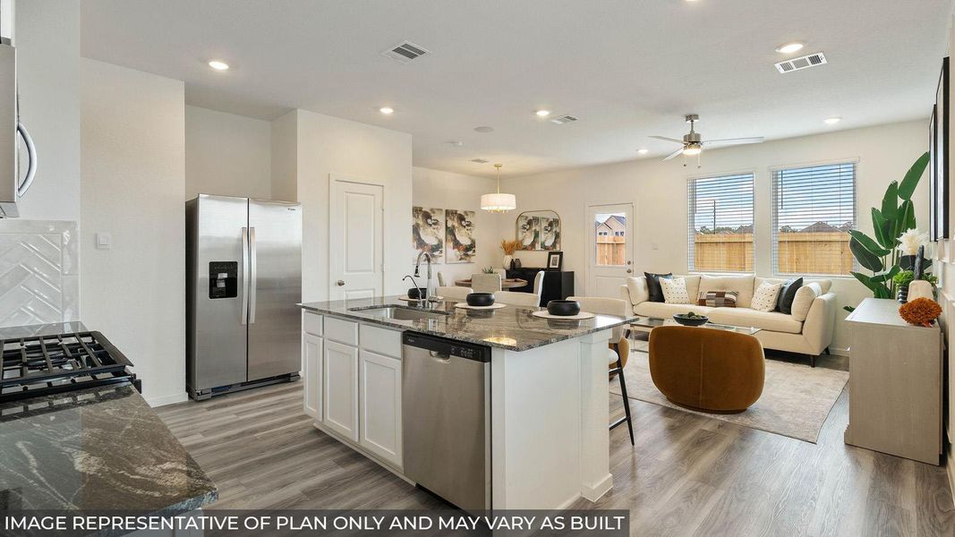 Open-concept living area with wood-finish flooring, a kitchen island, and stainless steel appliances