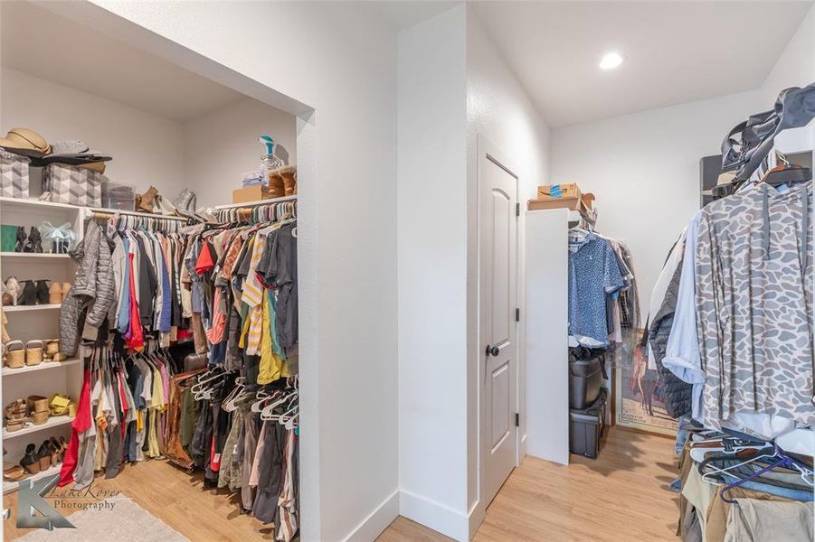 Spacious closet featuring light wood-type flooring Spacious closet featuring light wood-type flooring