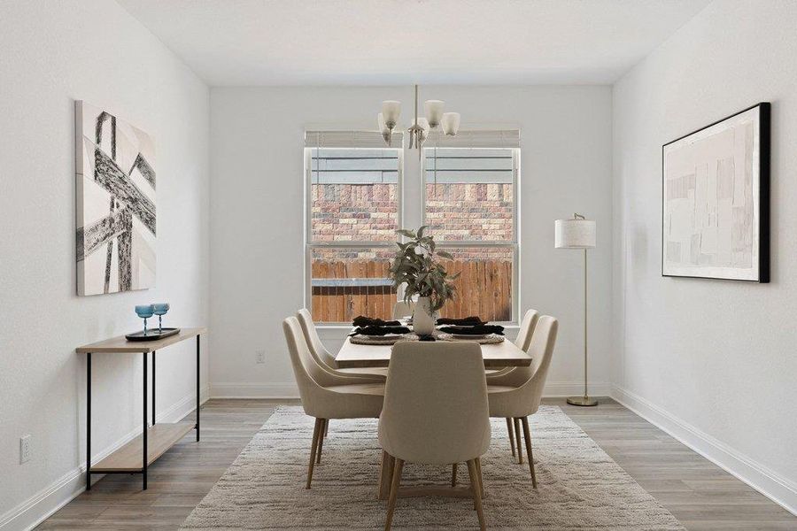 Dining space featuring light wood-style flooring and suspended lighting Dining space featuring light wood-style flooring and suspended lighting