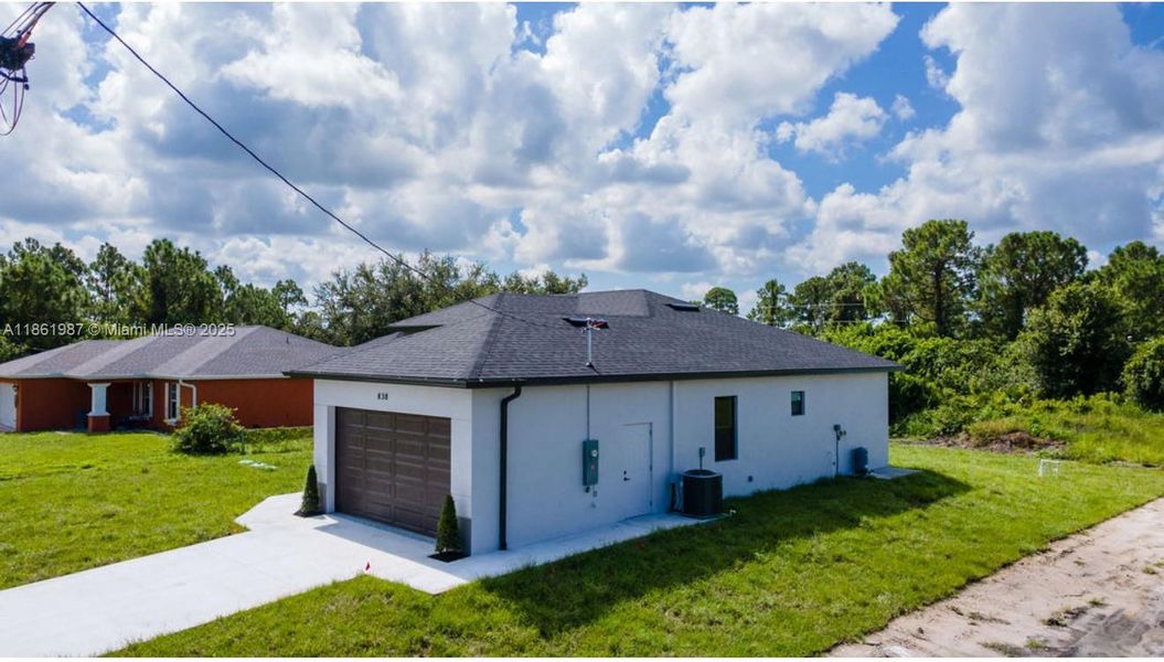 Front exterior of a new home in , Lehigh Acres, FL, highlighting curb appeal (Image 17). Front exterior of a new home in , Lehigh Acres, FL, highlighting curb appeal (Image 17).