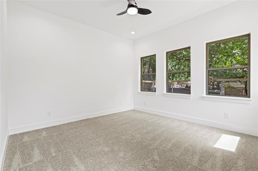 Spare room featuring ceiling fan and carpet floors