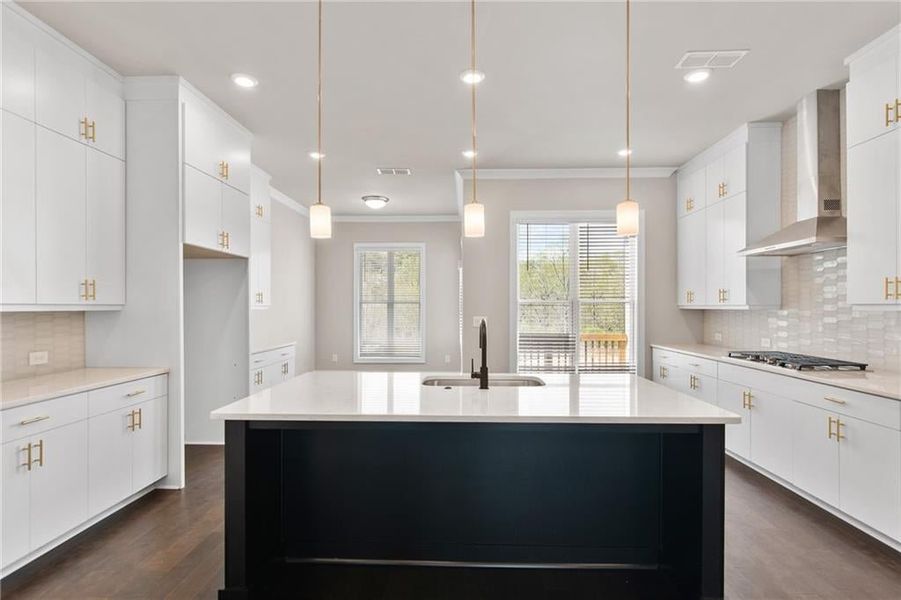 The large kitchen island at homesite 102 will be Riverstone gray. Photos are not of the exact property but are similar, the home is currently under construction.