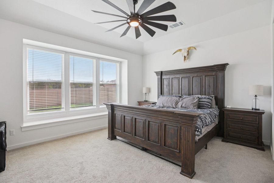 Bedroom with light carpet and a ceiling fan Bedroom with light carpet and a ceiling fan