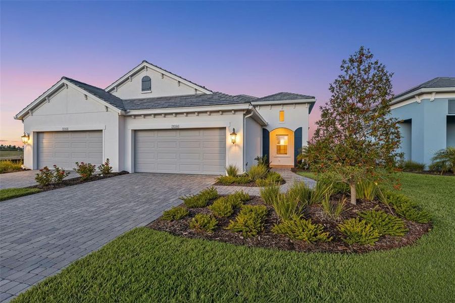 Front exterior of a new home in Palm Grove, Lakewood Ranch, FL, highlighting curb appeal (Image 1). Front exterior of a new home in Palm Grove, Lakewood Ranch, FL, highlighting curb appeal (Image 1).