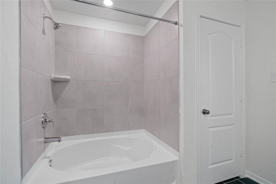 The oversized tub and shower combination with tile surround.