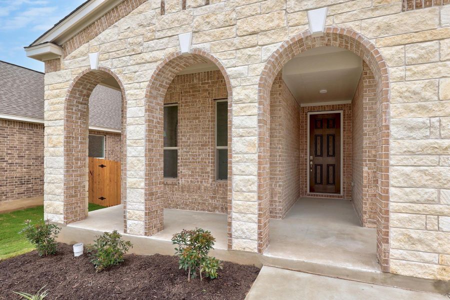 Front exterior of a new home in Salerno - Classic Collection, Round Rock, TX, highlighting curb appeal (Image 18). Front exterior of a new home in Salerno - Classic Collection, Round Rock, TX, highlighting curb appeal (Image 18).