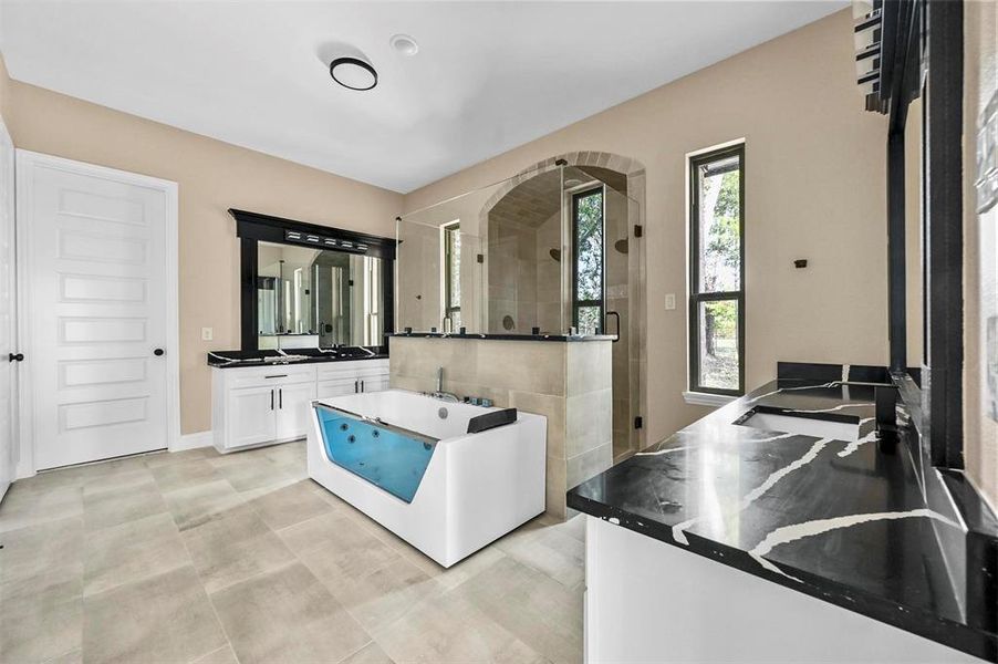 Kitchen featuring white cabinetry and light tile patterned floors