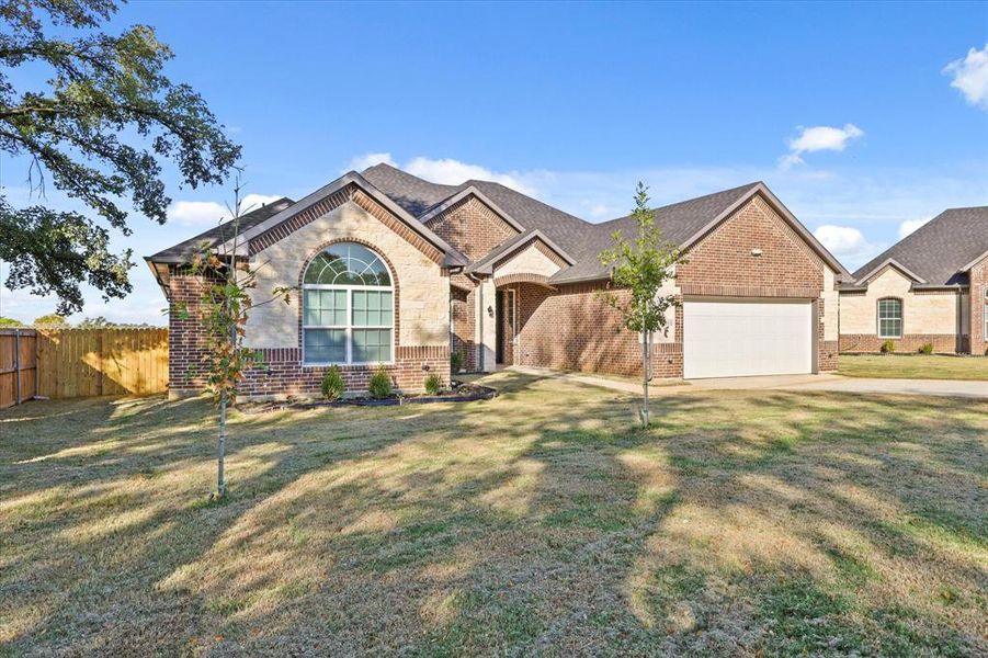 View of front of house with a front lawn and a garage