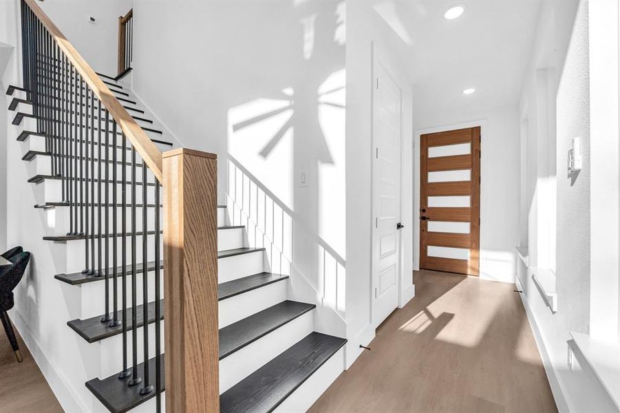 Staircase featuring hardwood / wood-style flooring