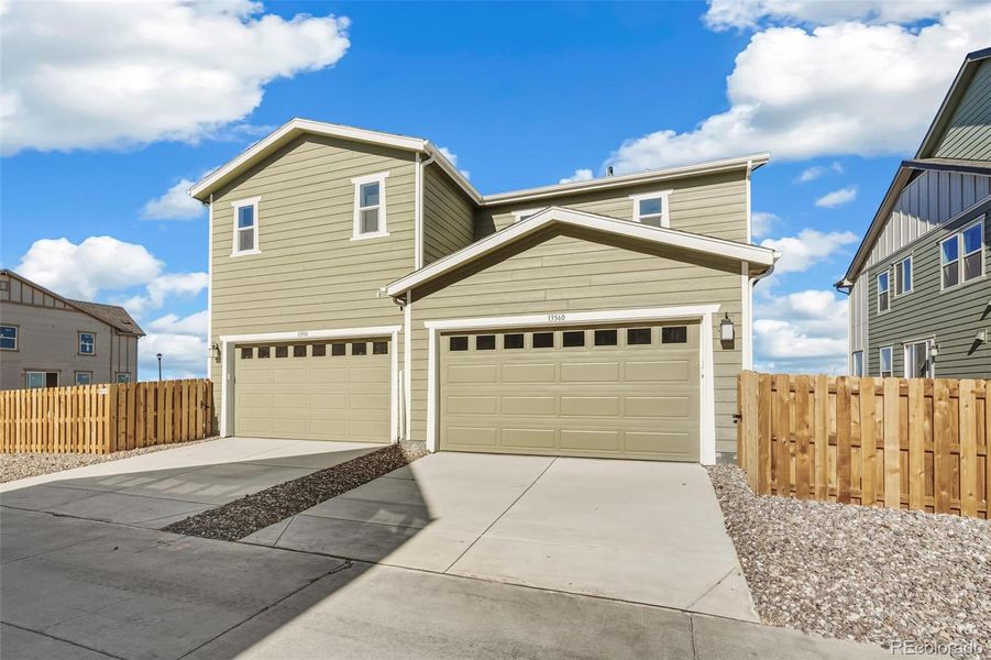 Front exterior of a new home in Turnberry, Commerce City, CO, highlighting curb appeal (Image 23).