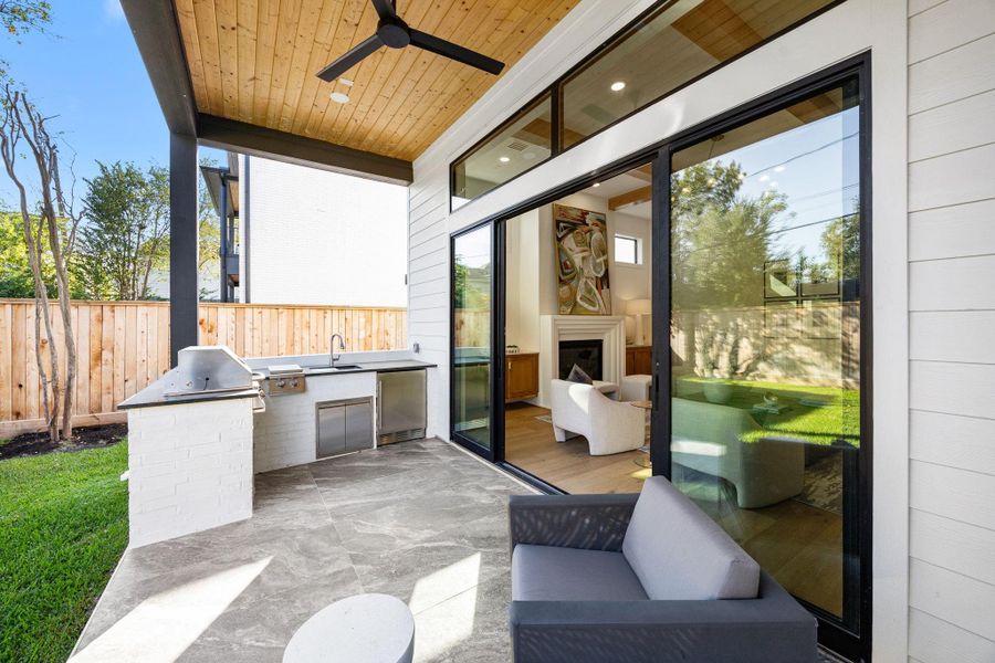 Relax on your covered patio w/ Summer Kitchen. Wall of windows can open up to let the breeze in on a nice day. Relax on your covered patio w/ Summer Kitchen. Wall of windows can open up to let the breeze in on a nice day.