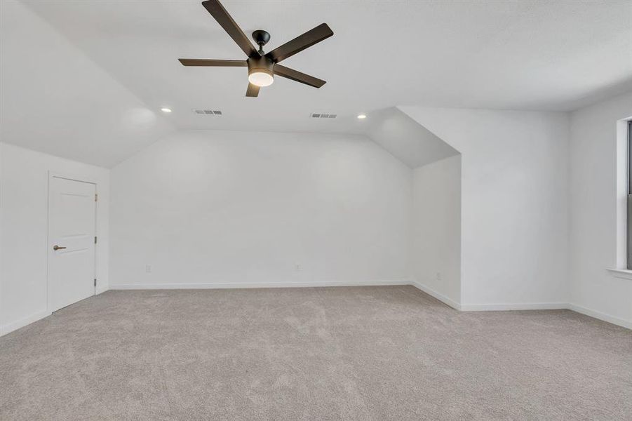 Additional living space with vaulted ceiling, light carpet, recessed lighting, and ceiling fan