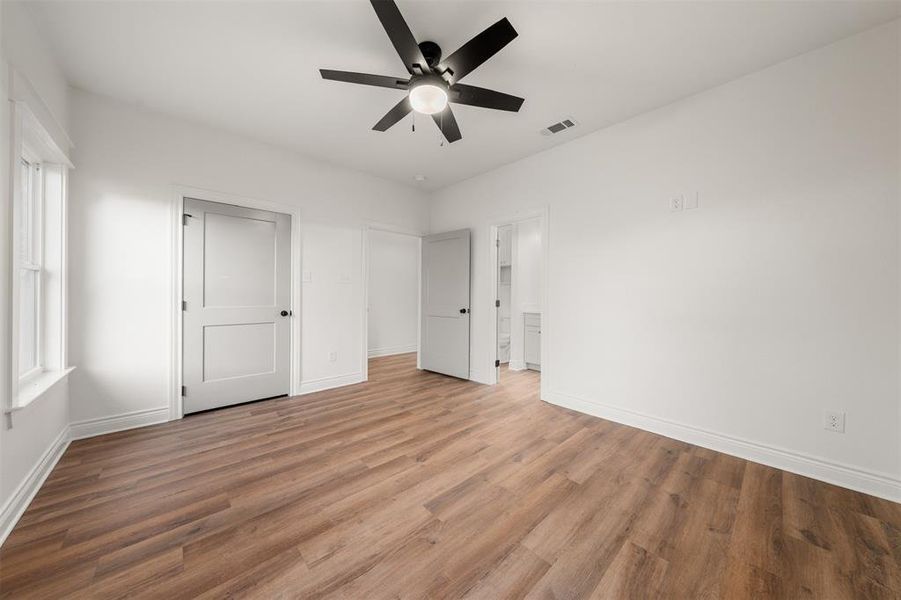 Unfurnished bedroom with wood finished floors and ceiling fan Unfurnished bedroom with wood finished floors and ceiling fan