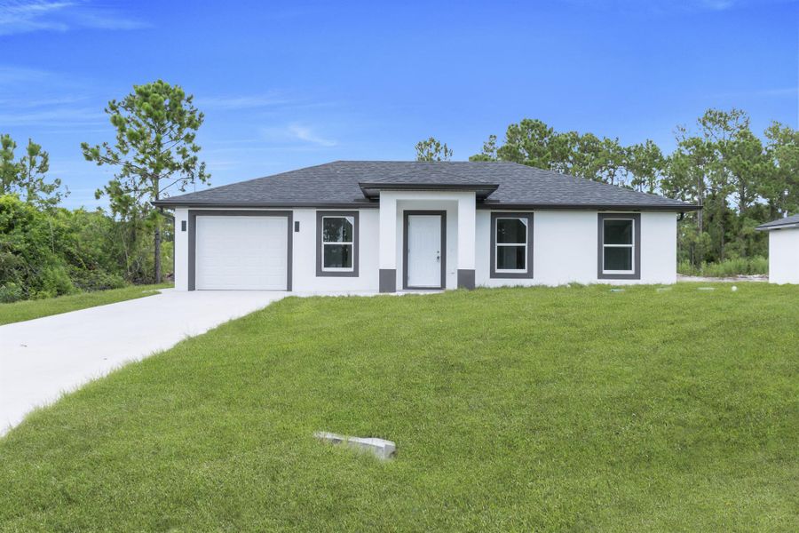 Front exterior of a new home in , Lehigh Acres, FL, highlighting curb appeal (Image 22).