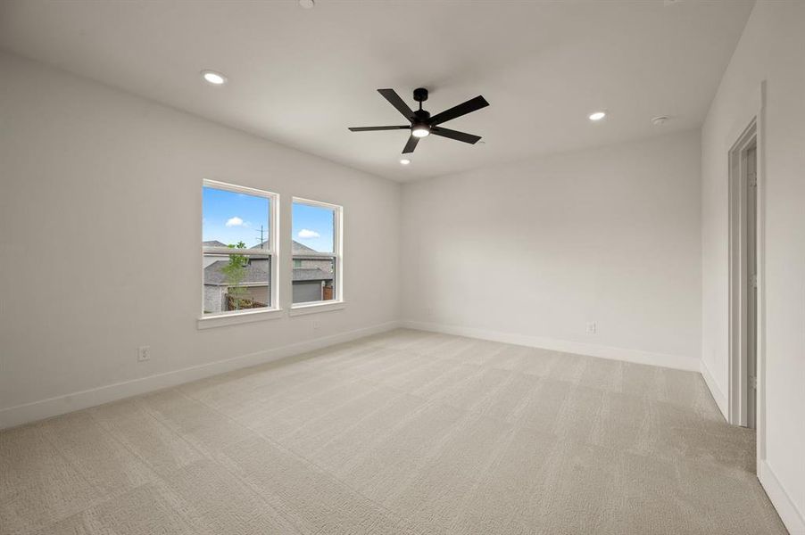 This owner's suite with large windows and neutral colors is the perfect place to relax and unwind at the end of the day.