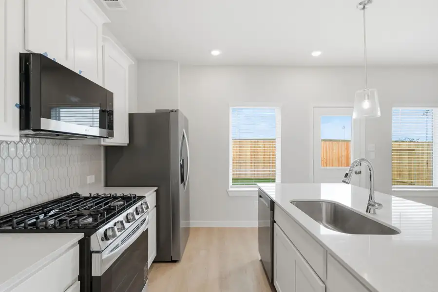 A kitchen with white cabinets. A kitchen with white cabinets.
