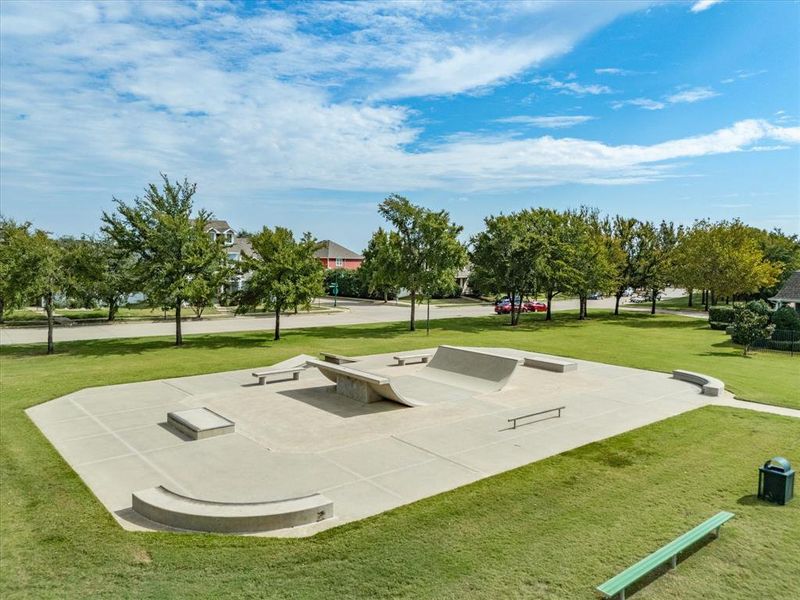 View of property's community with a patio area and a lawn View of property's community with a patio area and a lawn
