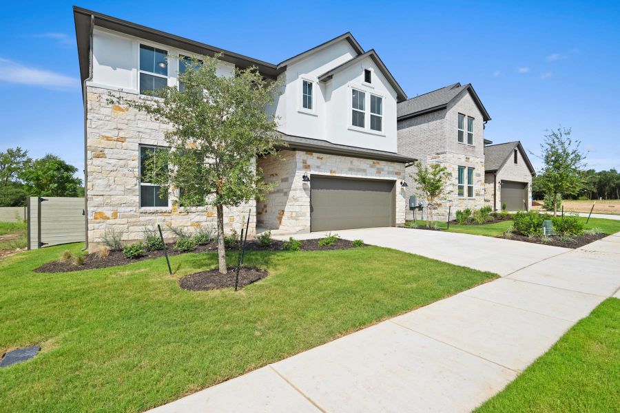 Front exterior of a new home in Wolf Ranch, Georgetown, TX, highlighting curb appeal (Image 25).