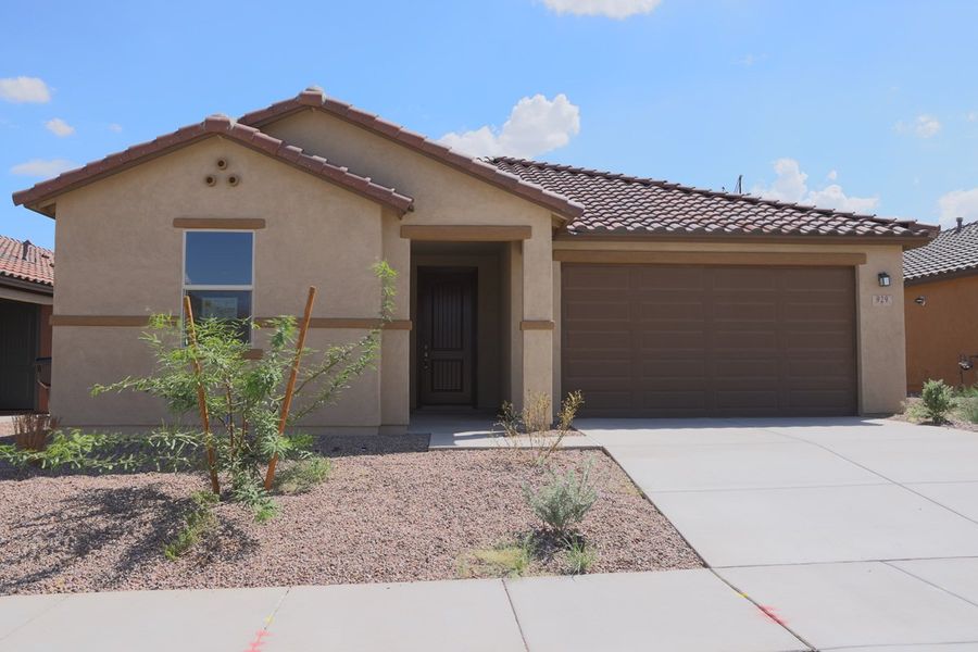 Front exterior of a new home in Entrada Del Pueblo at Rancho Sahuarita, Sahuarita, AZ, highlighting curb appeal (Image 1). Front exterior of a new home in Entrada Del Pueblo at Rancho Sahuarita, Sahuarita, AZ, highlighting curb appeal (Image 1).