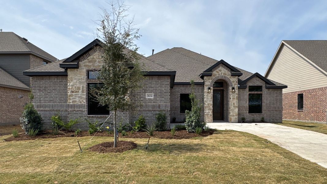Front exterior of a new home in Peachtree Meadows, Rockwall, TX, highlighting curb appeal (Image 2). Front exterior of a new home in Peachtree Meadows, Rockwall, TX, highlighting curb appeal (Image 2).