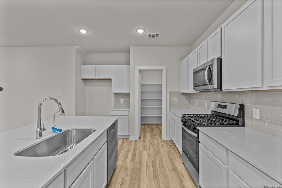 Furnished interior view inside a new home in Hacienda, San Antonio (Image 6).