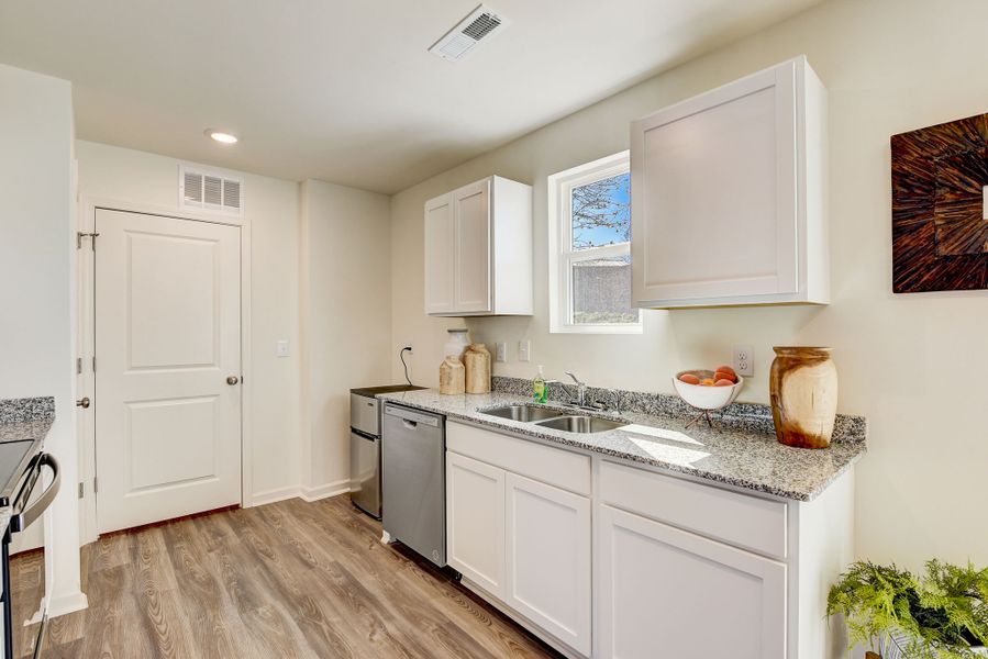 A kitchen with white cabinets. A kitchen with white cabinets.