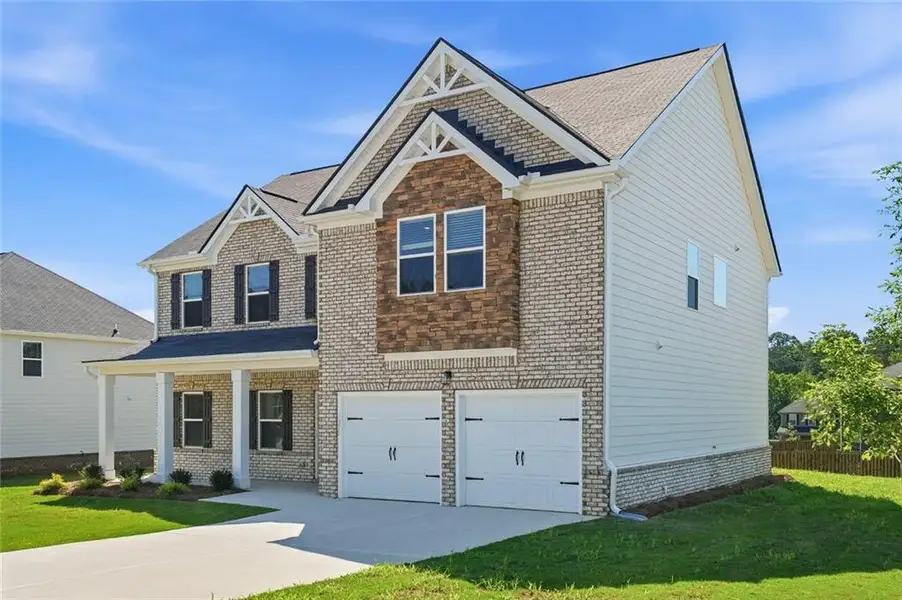 Front exterior of a new home in Southern Hills, McDonough, GA, highlighting curb appeal (Image 2). Front exterior of a new home in Southern Hills, McDonough, GA, highlighting curb appeal (Image 2).