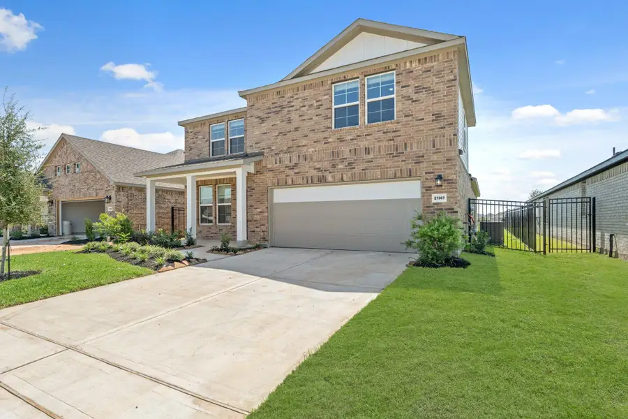 Front exterior of a new home in Sunterra, Katy, TX, highlighting curb appeal (Image 11). Front exterior of a new home in Sunterra, Katy, TX, highlighting curb appeal (Image 11).