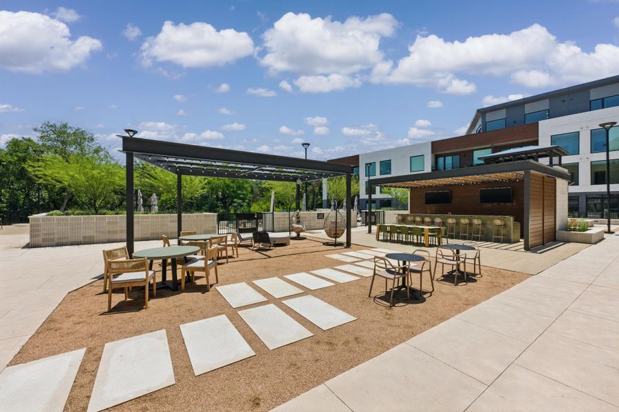 An inviting outdoor lounge area with varied seating and shaded dining spaces for community enjoyment.
