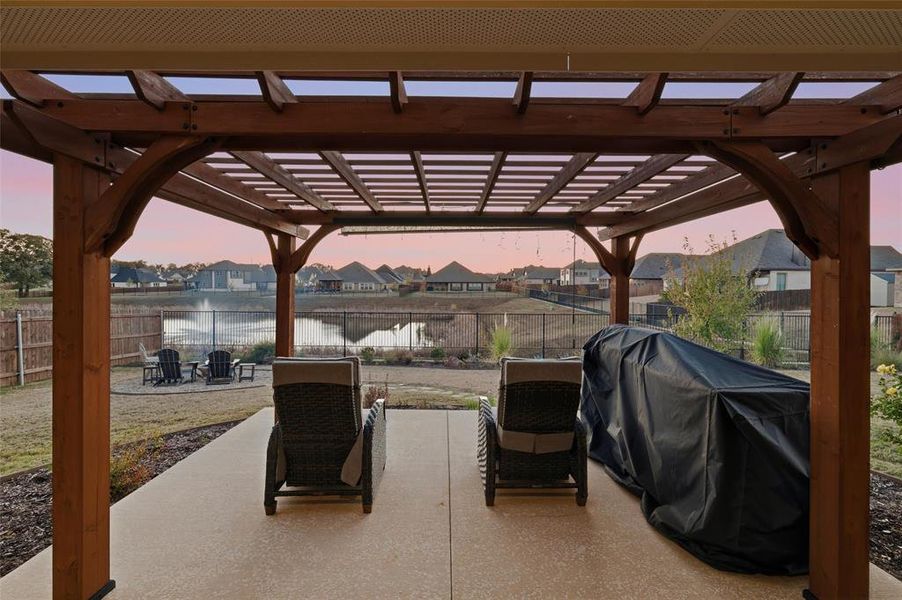 Pergola at twilight with views to pond, fountain and the fire pit Pergola at twilight with views to pond, fountain and the fire pit