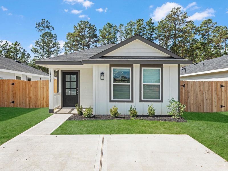 Front exterior of a new home in William Trails, Willis, TX, highlighting curb appeal (Image 17).