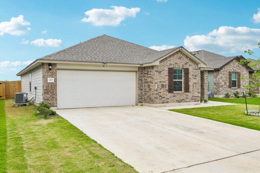 Brick and siding exterior with a two-car garage