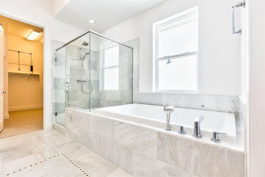 gorgeous bright primary bathroom with big window for natural light