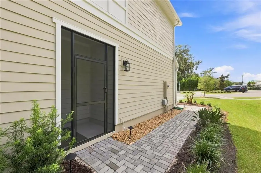 Exterior details and patio area of a home in Towns at Riverwalk, Sanford (Image 3). Exterior details and patio area of a home in Towns at Riverwalk, Sanford (Image 3).