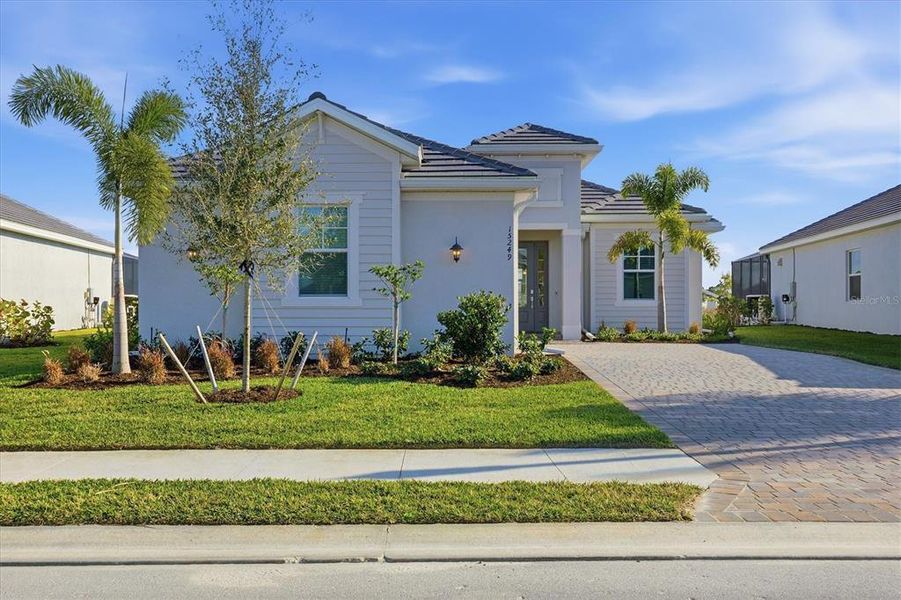 Front exterior of a new home in Heritage Landing, Punta Gorda, FL, highlighting curb appeal (Image 29).