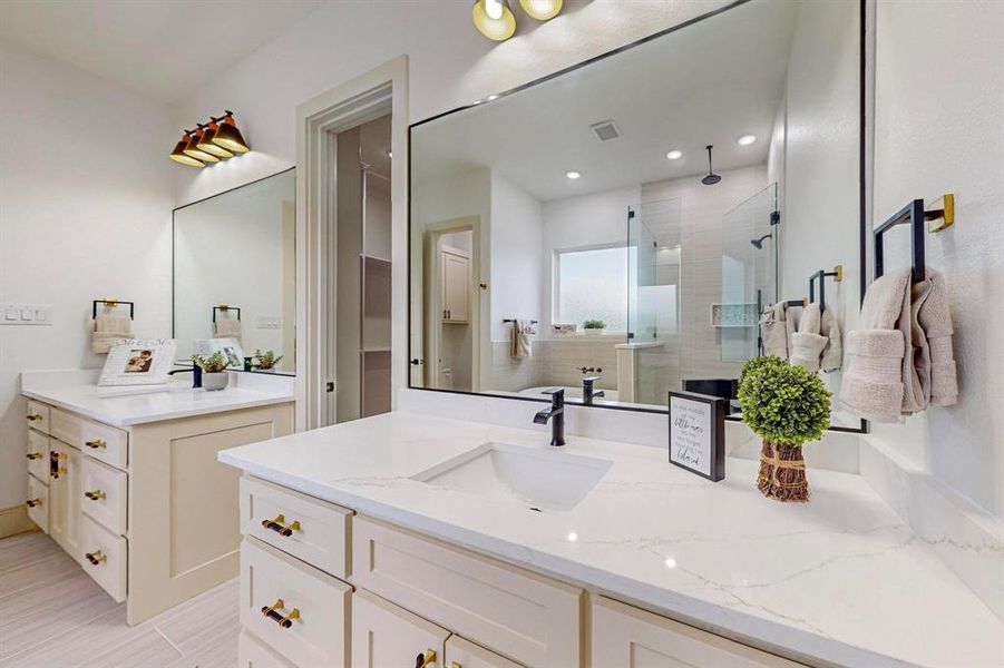 Bathroom featuring vanity and a shower with door