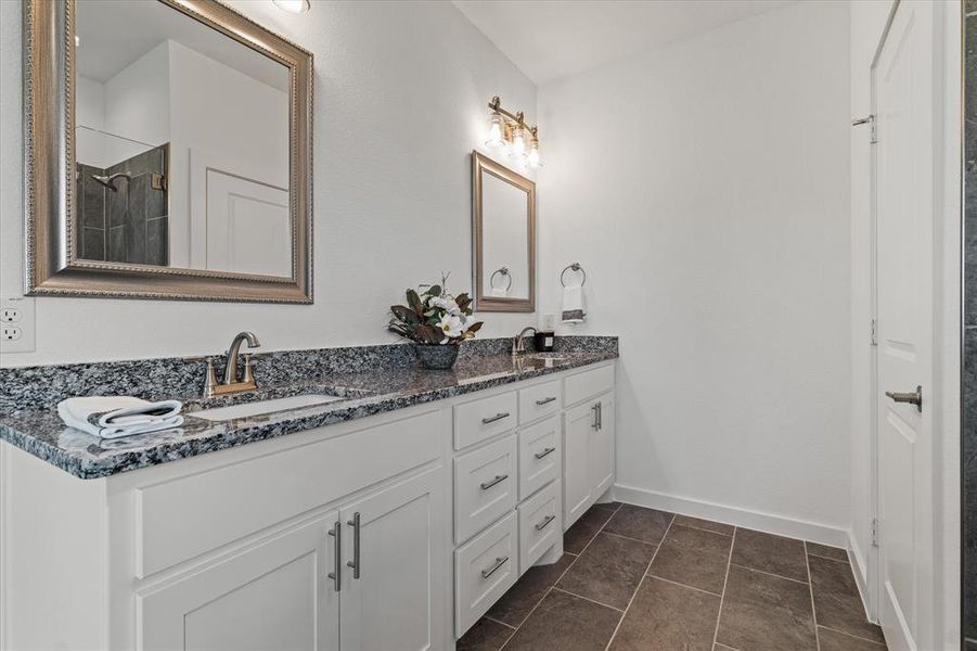 Bathroom with tile patterned floors and vanity