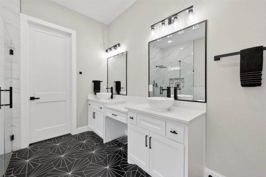 Dual-sink vanity with ample storage and modern lighting. Dual-sink vanity with ample storage and modern lighting.
